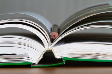 open book and pencil
