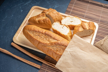 Baked baguette and multigrain loaf bread in Paper bag ready to serve.