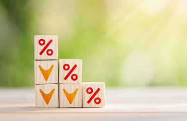 Interest rate financial and mortgage rates concept. Wooden cube block with interest rate and down arrow. Mortgage rates business concept of investment real estate interest rates appraisal.
