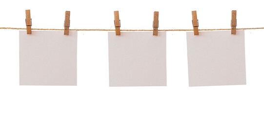 Three frames that hang on a rope with clothespins and isolated on white. Blank cards on rope mockup...