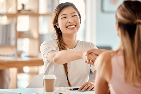 Business women, interview and handshake by happy, smile and hand of hr in support of deal, contract and hiring in office. Hand shake, partnership and recruitment success by excited asian leader