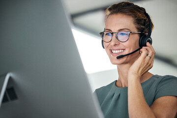 Customer service, woman and happy call center agent giving advice online using a headset. Operator, telemarketing and support with hotline consultant working for contact us help or arm consulting