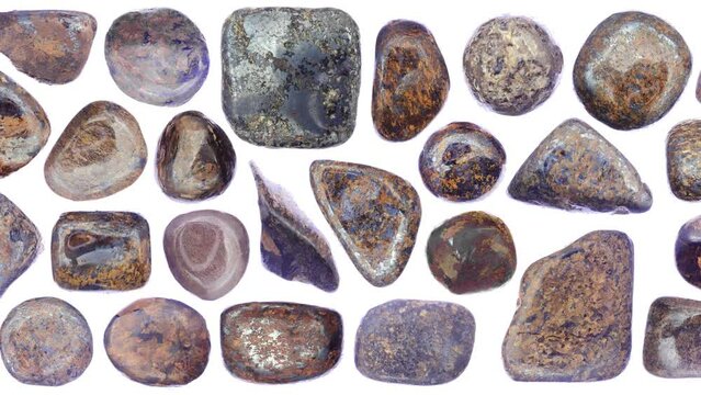 Bronzite jewel stones set texture on white light isolated background. Moving right seamless loop backdrop.