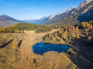 Aerial drone image of the mountain lake Lai Nair on the hiking area of Tarasp, Canton Grisons, Switzerland