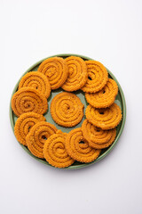 Chakli is a savoury snack from India. It is a spiral shaped snack with a spiked surface