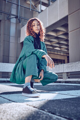 Trendy, style and cool teenage girl portrait in an urban city alone. Fashion, street style and...