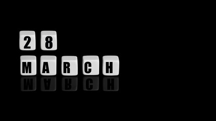 March 28th. Day 28 of month, Calendar date. White cubes with text on black background with reflection.Spring month, day of year concept