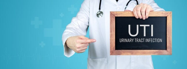 Urinary tract infection (UTI). Doctor shows medical term on a sign/board