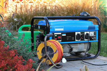 power generator standing in the garden. - obrazy, fototapety, plakaty