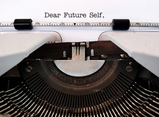 Vintage typewriter with type text DEAR FUTURE SELF, a letter to convey message to future you. specific goals to achieve, follow up on bucket list items or declare important affirmation