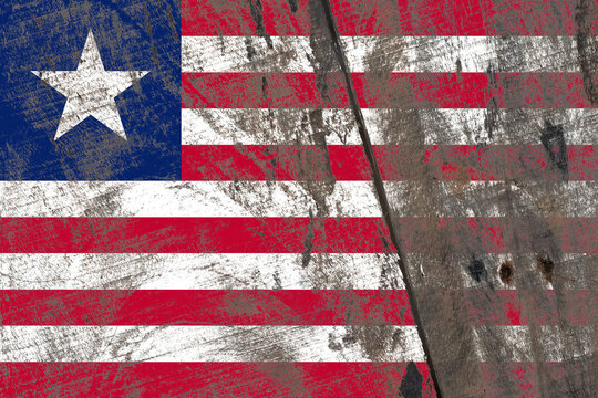 Liberia flag painted on a damaged old wooden background