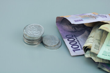 collection of Indonesian state banknotes and coins, with gray copy space or negative space, Indonesian rupiah