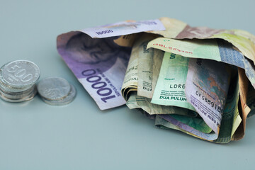 collection of Indonesian state banknotes and coins, with gray copy space or negative space, Indonesian rupiah