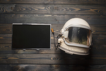 Concept of astronaut helmet and blank screen computer monitor with copy space on the table of the...