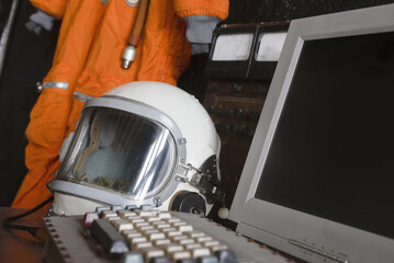 Concept of astronaut helmet on the table of the orbital station background. © Dmitriy