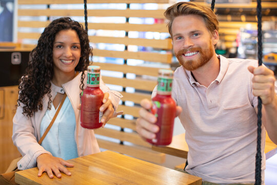 good looking young couple enjoying some healthy smoothies
