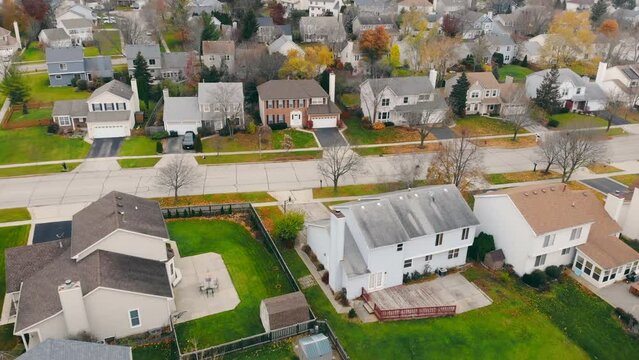 Aerial drone view of American suburban neighborhood. Establishing shot of America's suburb. Residential single family houses pattern. Autumn Fall season