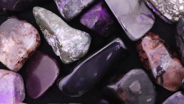 Sugilite heap jewel texture background. Moving right seamless loop backdrop.