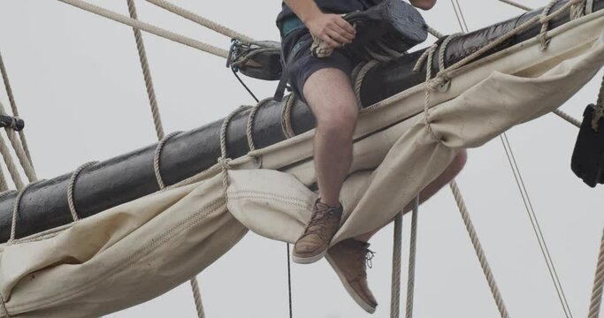 Ferdinand Magellan Nao Victoria carrack boat replica mast with worker fixing ropes in slow motion 60fps