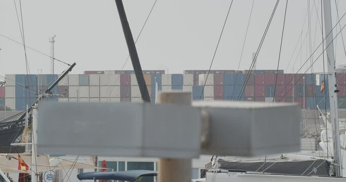 Ferdinand Magellan Nao Victoria carrack boat replica with spanish flag enters wharf in Valencia with containers in the background in slow motion 60fps