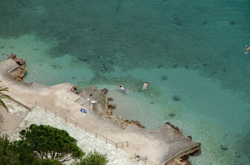 Aerial view. swimmers on green waters at Nafplion city, Greece.