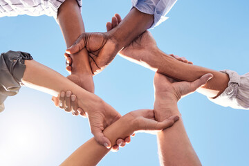 Hands, community and link team together global community of cooperation on blue sky. Group...