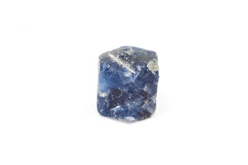 Real raw hexagonal deep blue sapphire, aluminium corundum crystal uncut natural stone macro isolated on a white surface background