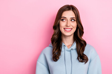 Obraz premium Photo of charming dreamy young lady wear grey hoodie smiling looking empty space isolated pink color background