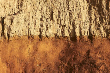 Close up surface of orange brown clay texture of a cliff