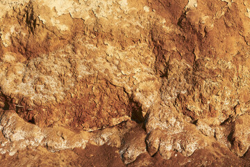 Close up surface of orange brown clay texture of a cliff