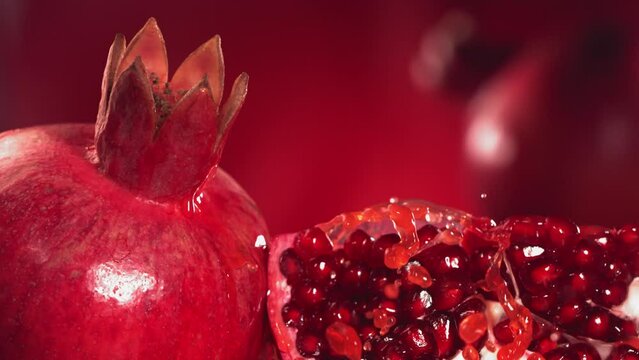 Slow Motion Shot of Pomegranate Juice Splashing through Pomegranate Slices