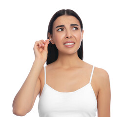 Fototapeta premium Young woman cleaning ear with cotton swab on white background