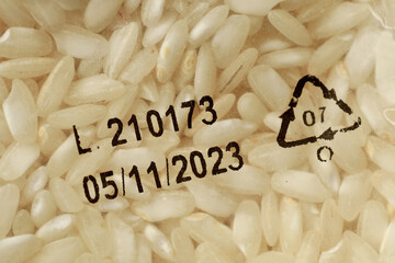 Close-up of expiration date on white rice packaging