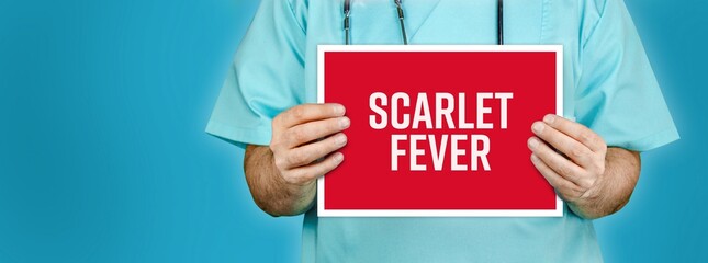 Scarlet fever. Doctor shows red sign with medical word on it. Blue background.