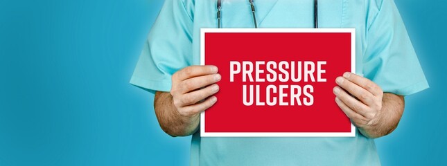 Pressure ulcers (bedsores). Doctor shows red sign with medical word on it. Blue background.