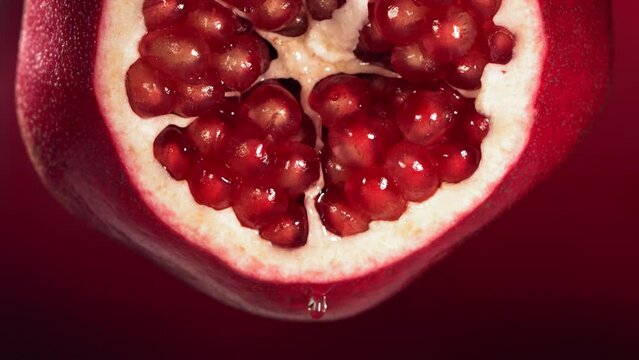 Slow Motion of Water Drip Drop from Half Pomegranate