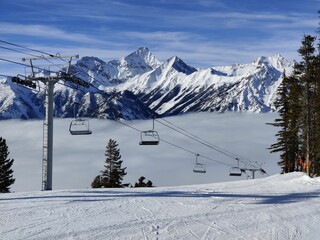 Landscape shot of chairlift in the snowy high mountains in Panorama Mountain Resort, Canada