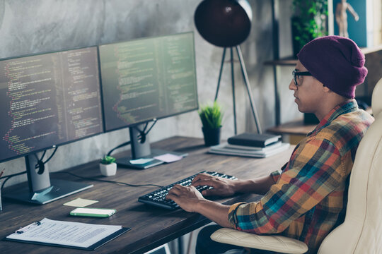 Photo of serious confident guy dressed eyewear hat typing code modern device indoors workstation workshop home