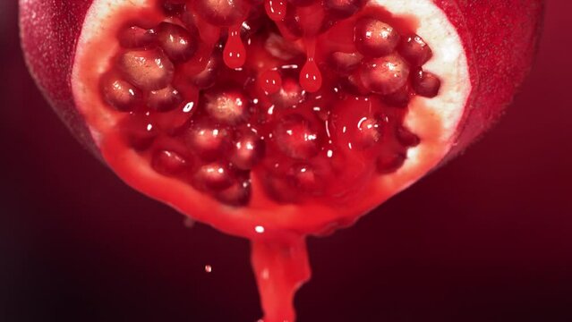 Slow Motion of Flowing Pomegranate Juice from Half Pomegranate