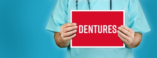 Dentures (false teeth). Doctor shows red sign with medical word on it. Blue background.