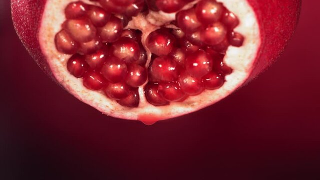 Slow Motion of Juice Drip Drop from Half Pomegranate