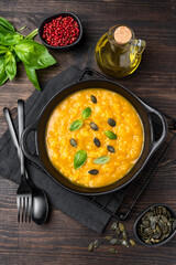 Risotto with pumpkin and pumpkin seeds, parmesan cheese and basil. risotto alla milanese with saffron. italian cuisine seasonal fall menu
