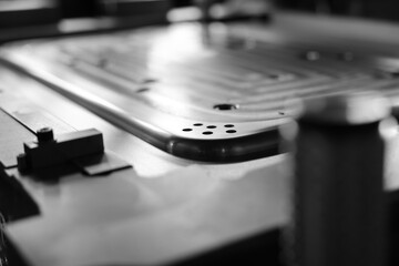 Sheet Metal Stamping Tool Die for Automotive Precision Parts on The Numerical Control Milling Machine Table. Tandem Stamping System. At a High Quality Technology Factory. Black and White Photography.