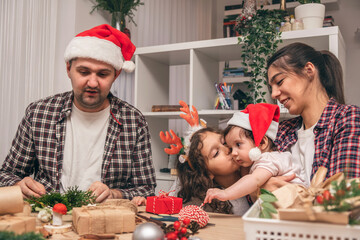 A happy family is preparing for Christmas and New Year,packing and decorating gifts at home.Upcoming holidays and celebrations.