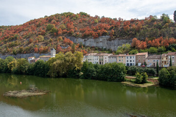 Fototapeta na wymiar Drought turns trees brown in mid summer on the hills along the river Lot in Cahors, France . Seen from the Loius Philippe bridge
