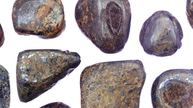 Bronzite rare jewel stones texture on white light isolated background. Moving right seamless loop backdrop.
