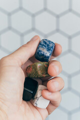 Hand holding healing crystals