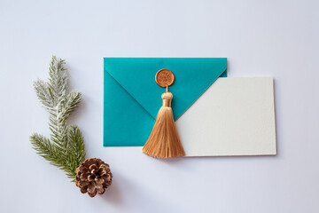 Turquoise envelope with a white sheet of paper and New Year's attributes