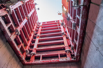 Formwork panels connected by clamps at the construction of an elevator shaft.