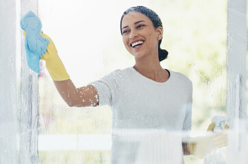 Cleaning, glass and shower door with woman in bathroom for hygiene, bacteria and sanitize. Smile,...
